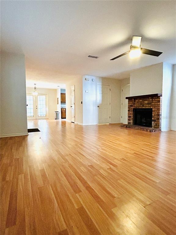 5221 Southwest 97 Drive Gainesville, FL 32608 - Photo 3 of 13 a view of a livingroom with wooden floor and a fireplace