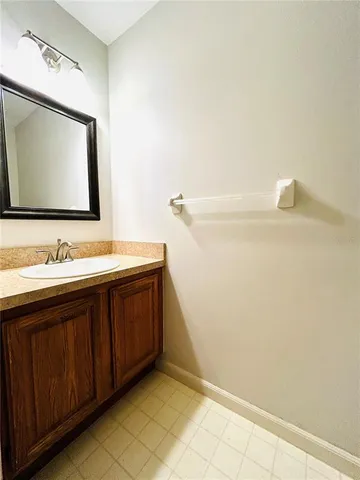 a bathroom with a sink vanity and mirror