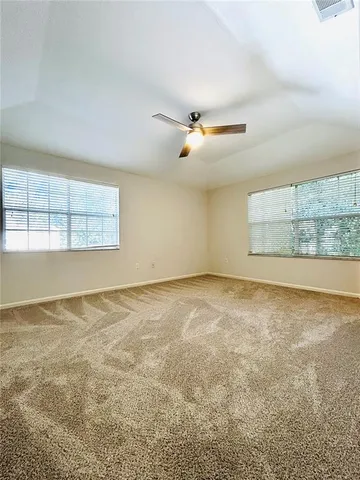 an empty room with a empty space and windows