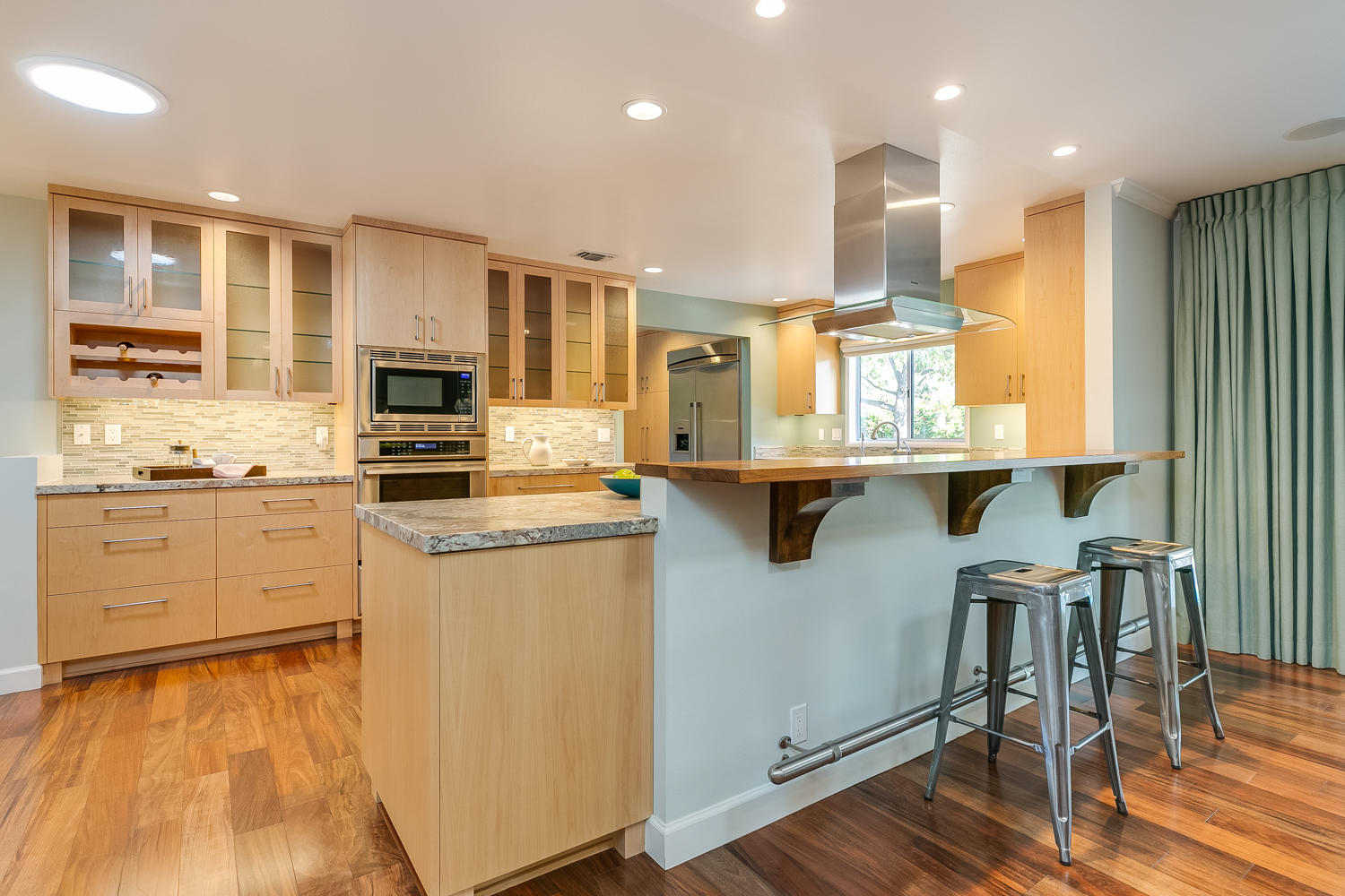 417 Andrew Drive Ojai, CA 93023 - Photo 15 of 31 a kitchen with kitchen island granite countertop wooden floors and white cabinets