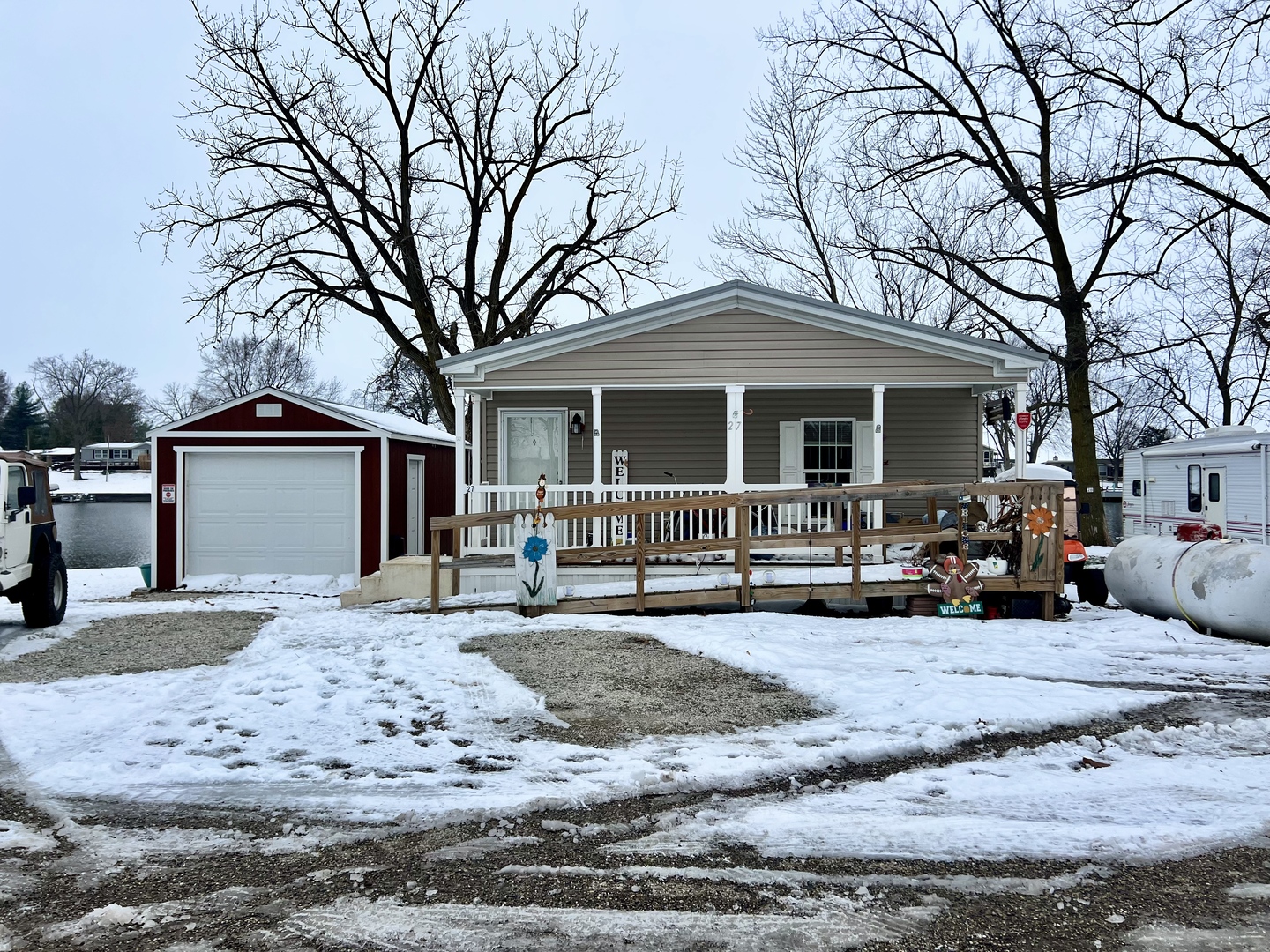 a view of a house with a yard covered in snow