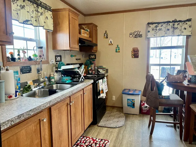 a kitchen with a sink stove and cabinets