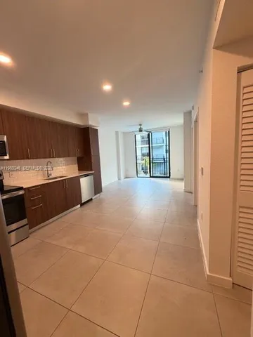 a large kitchen with a stove and a refrigerator