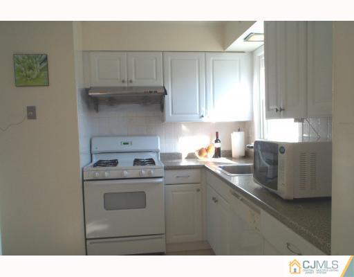 10 Sulliman Road Edison, NJ 08817 - Photo 4 of 9 a kitchen with a cabinets and white appliances