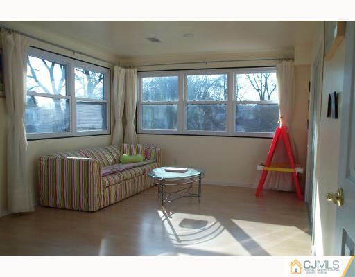 10 Sulliman Road Edison, NJ 08817 - Photo 6 of 9 a living room with a couch and a table