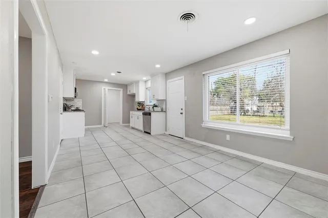 a view of an empty room and a window