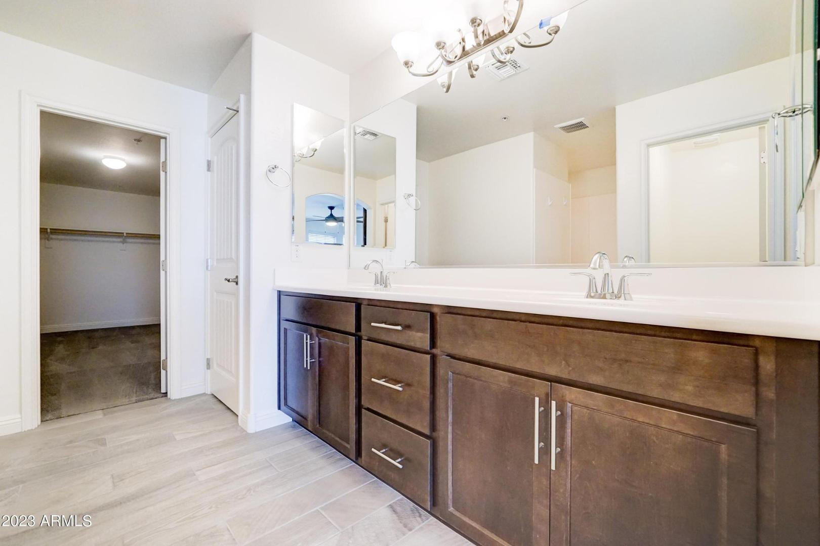 2297 North Alsap Road Buckeye, AZ 85396 - Photo 16 of 36 a bathroom with a double vanity sink and mirror