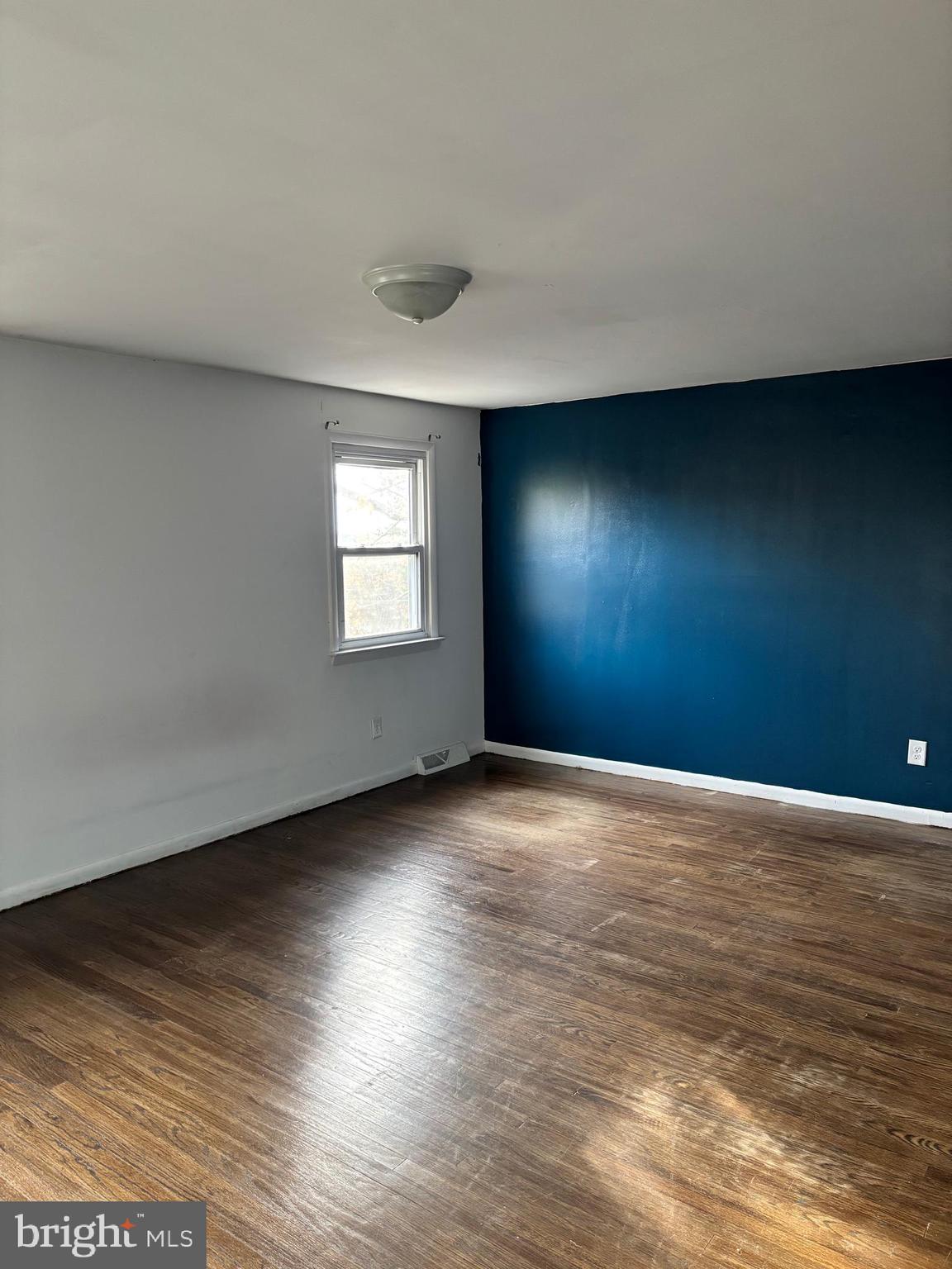 148 Diamond Avenue Pine Hill, NJ 08021 - Photo 27 of 35 a view of an empty room with window and wooden floor