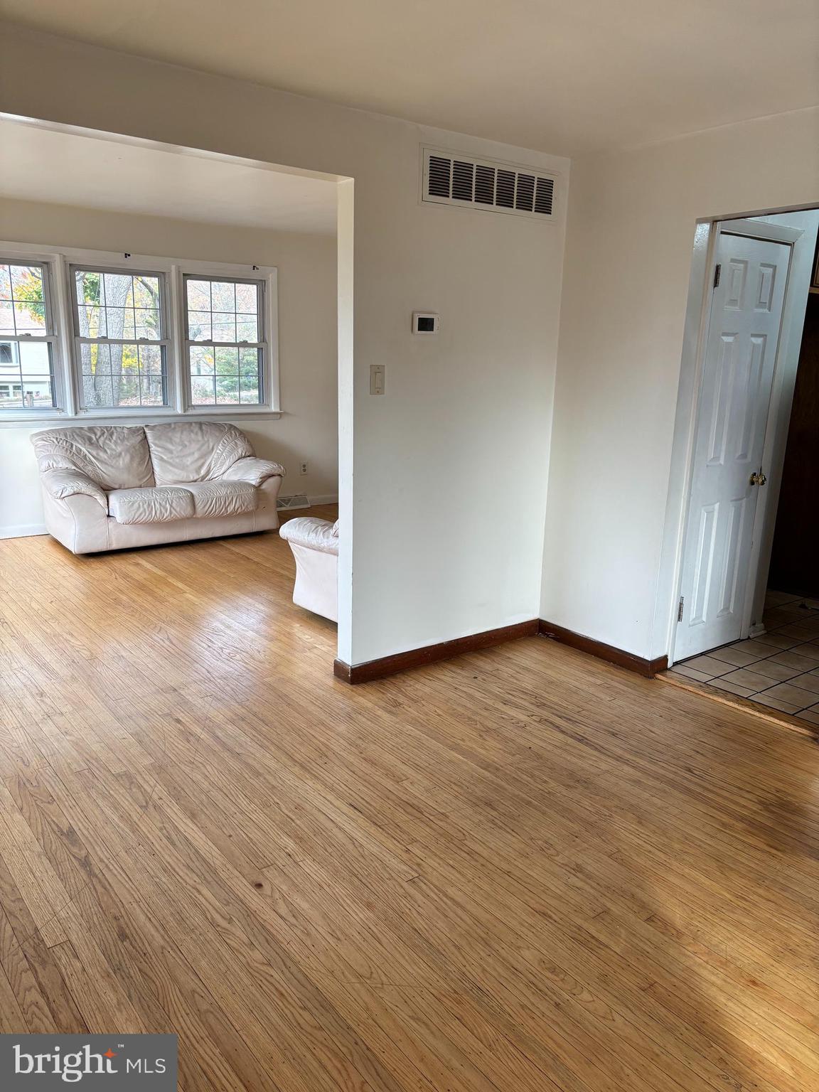 148 Diamond Avenue Pine Hill, NJ 08021 - Photo 5 of 35 an empty room with wooden floor and windows