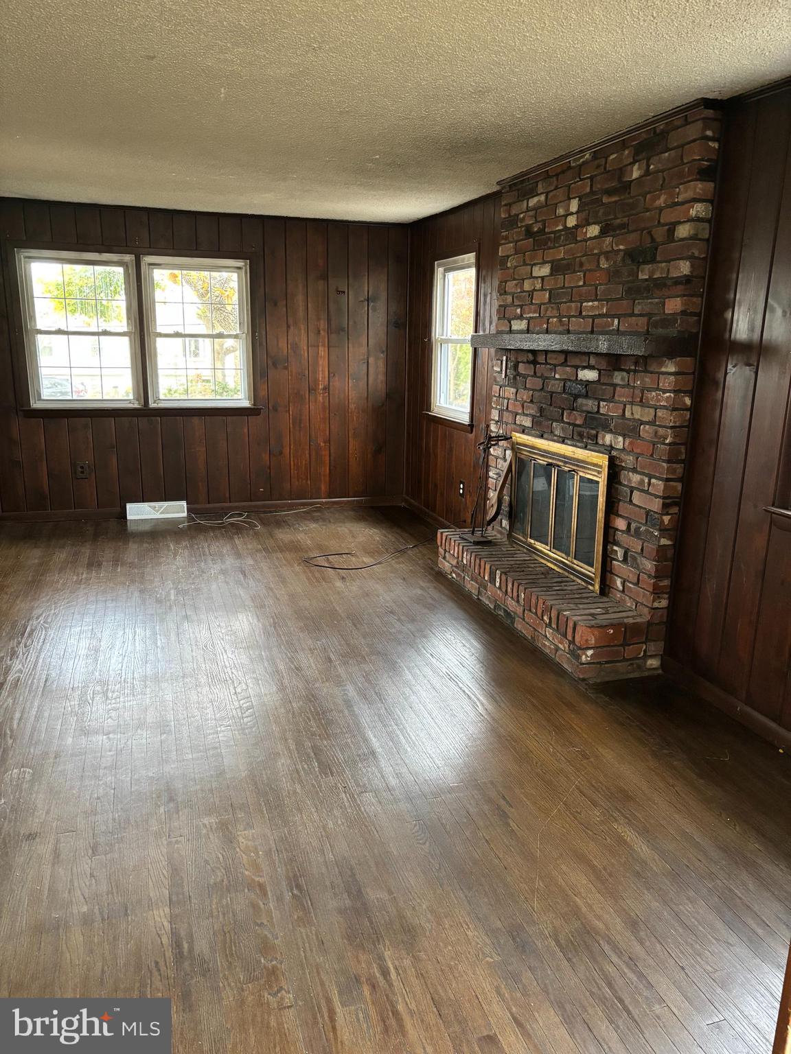 148 Diamond Avenue Pine Hill, NJ 08021 - Photo 7 of 35 an empty room with wooden floor fireplace and windows