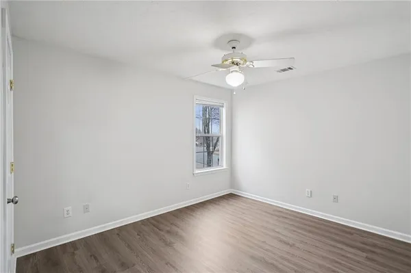 wooden floor in an empty room with a window