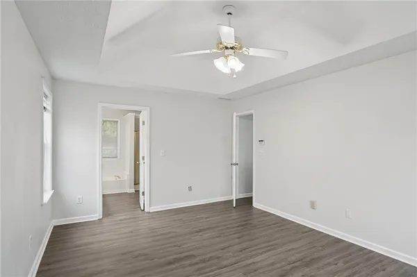 a view of an empty room with wooden floor