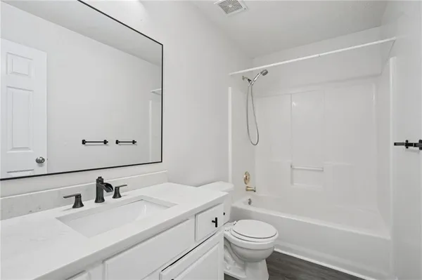 a bathroom with a sink toilet tub and shower