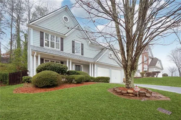 a front view of a house with a garden