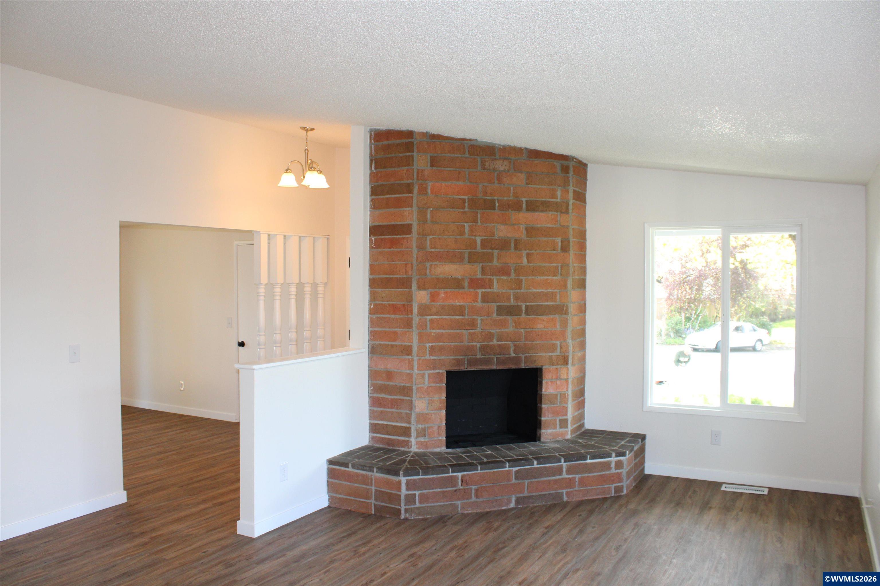 6259 Chapman Place Southwest Albany, OR 97321 - Photo 3 of 21 a living room with a fireplace and wooden floor