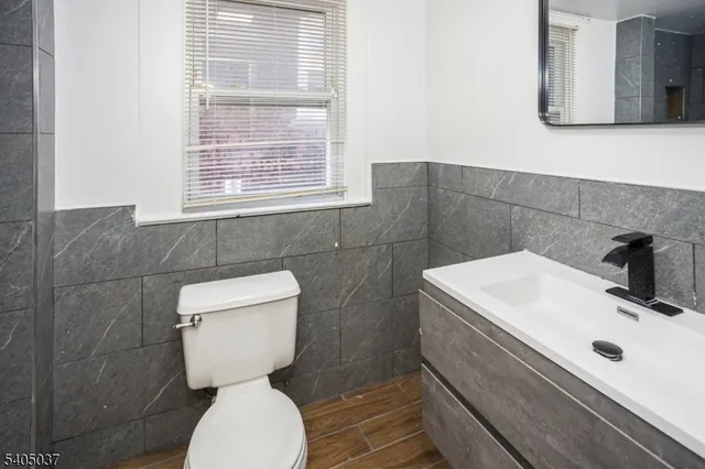 a bathroom with a toilet sink and mirror