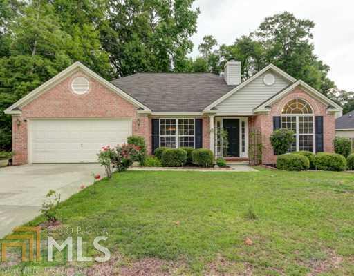 139 Brookstone Way, Unit 31 Rincon, GA 31326 - Photo 1 of 1 a front view of a house with a yard and garage