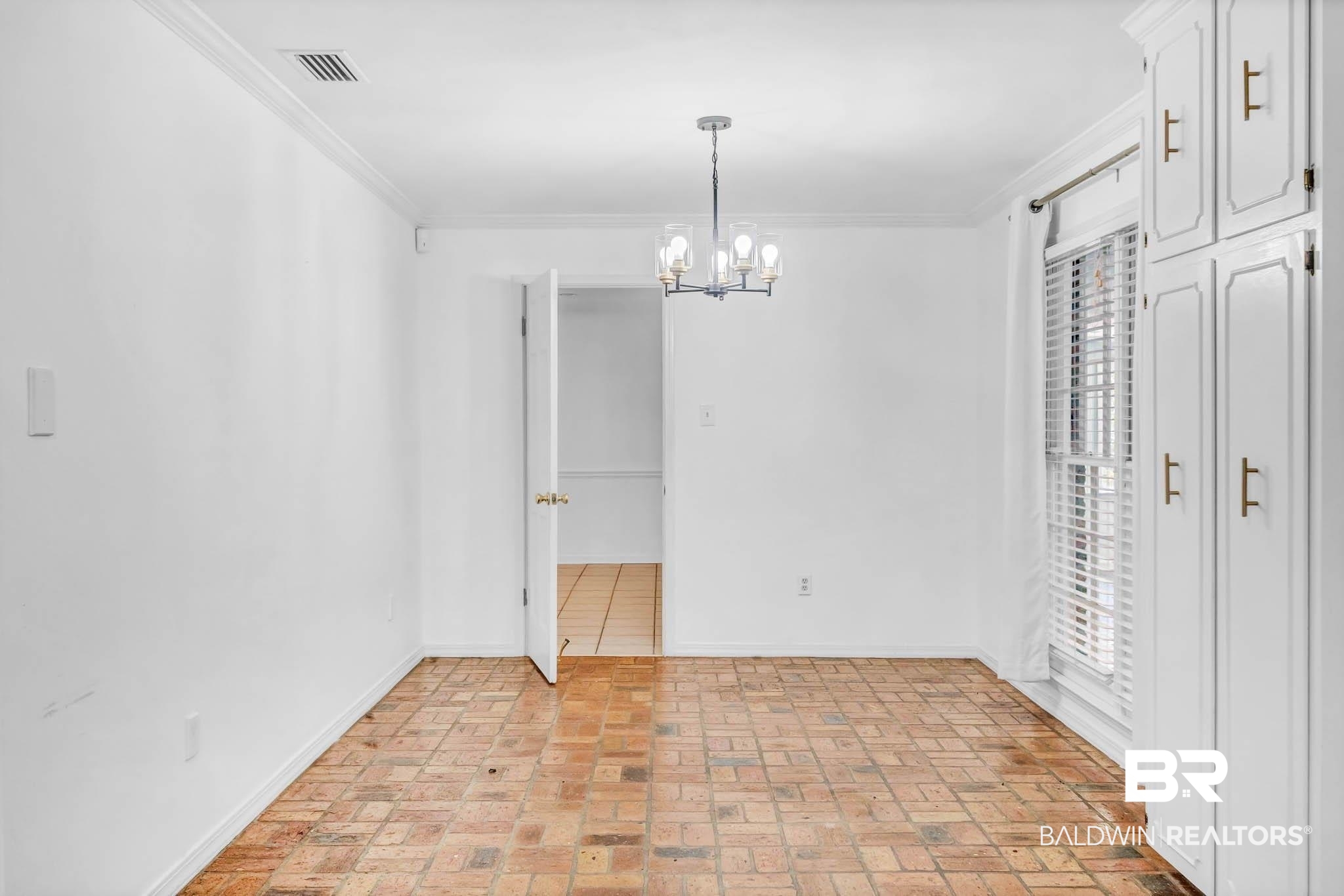 309 West Brandy Run Road Mobile, AL 36608 - Photo 23 of 100 Unfurnished dining area with ornamental molding, brick flooring, and a chandelier