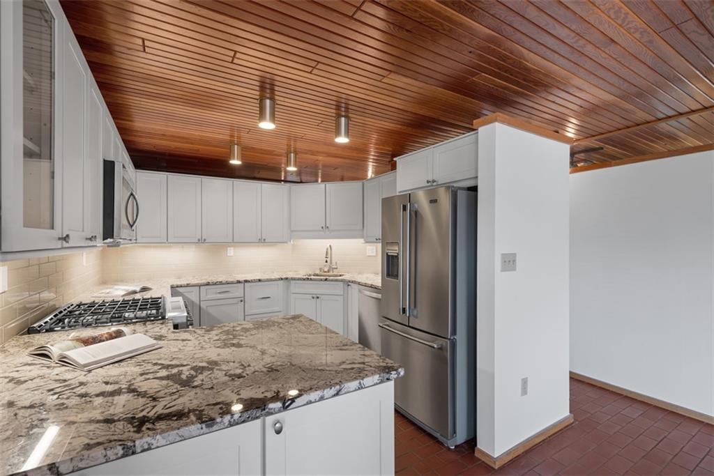 5 Bayard Road, Unit 219 Pittsburgh, PA 15213 - Photo 7 of 35 a kitchen with stainless steel appliances granite countertop a sink window and refrigerator
