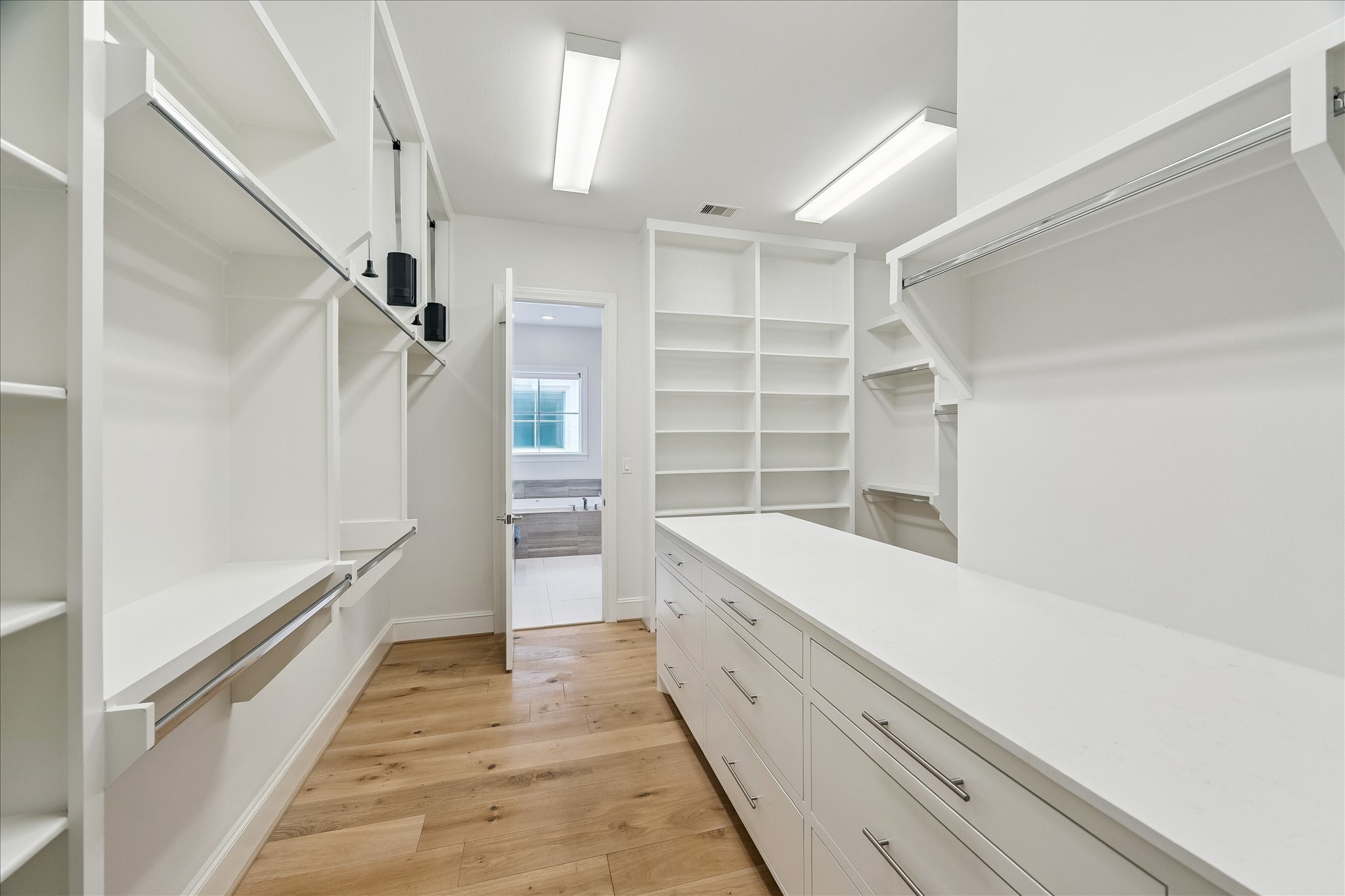 6108 Nicholas Grove Place Houston, TX 77055 - Photo 14 of 29 And then there's the closet. It's truly a standout space, complete with an extended stone-topped counter and an abundance of cabinetry below, making organization as beautiful as it is functional.