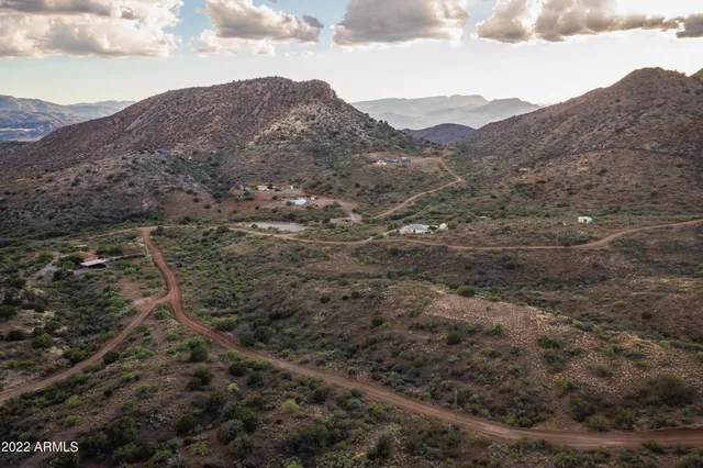 a view of a mountain in the distance in a field