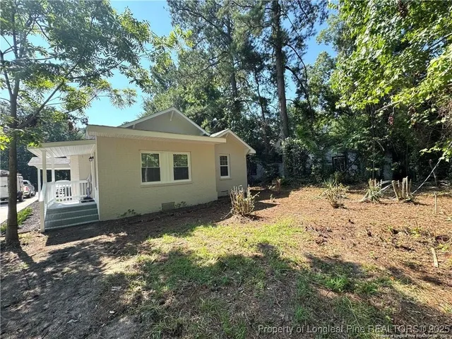 a view of a house with a yard covered in snow