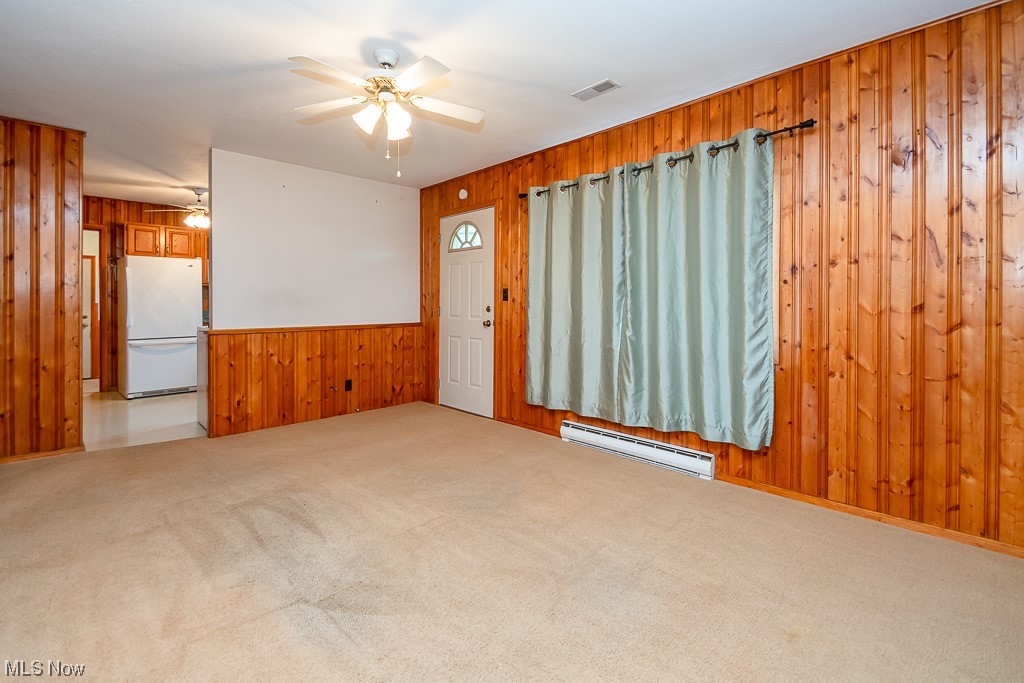 5 Pleasantview Vermilion, OH 44089 - Photo 5 of 37 Carpeted empty room featuring ceiling fan and baseboard heating