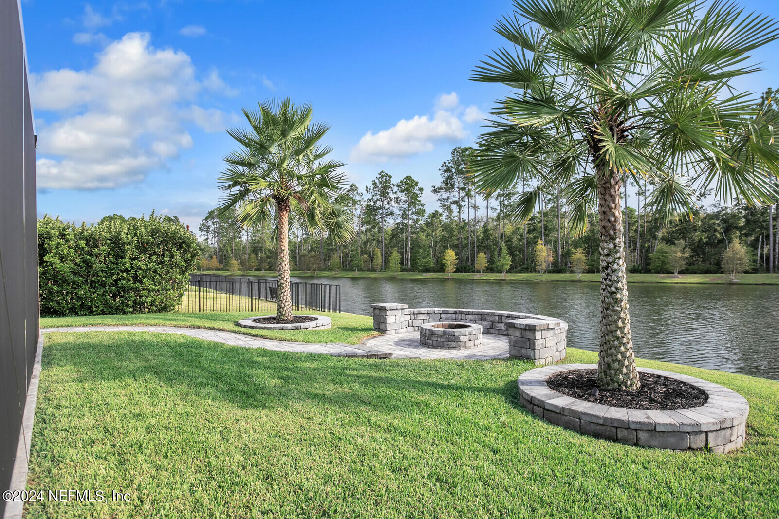 240 Pine Haven Drive St. Johns, FL 32259 - Photo 36 of 46 a swimming pool with lots of tress in front of it