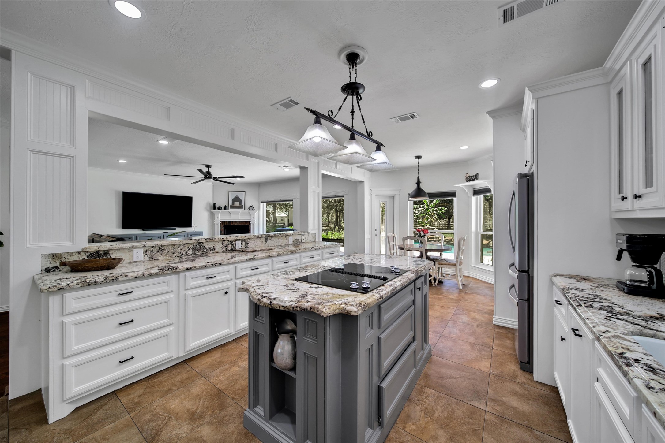 29919 Tudor Way Magnolia, TX 77355 - Photo 12 of 50 a kitchen with granite countertop a sink stove and refrigerator