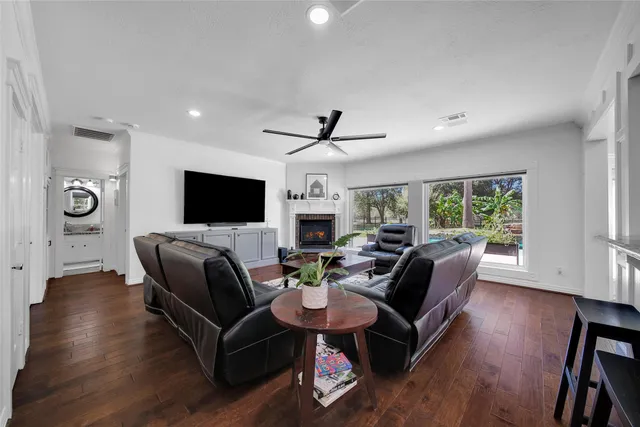 a living room with fireplace furniture and a flat screen tv