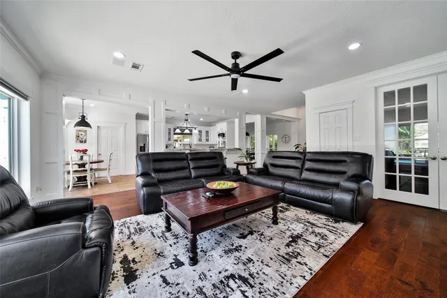 a living room with furniture and wooden floor