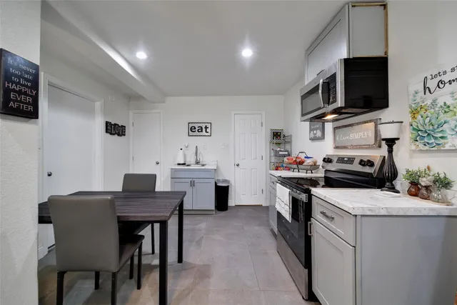 a kitchen that has a table and chairs in it