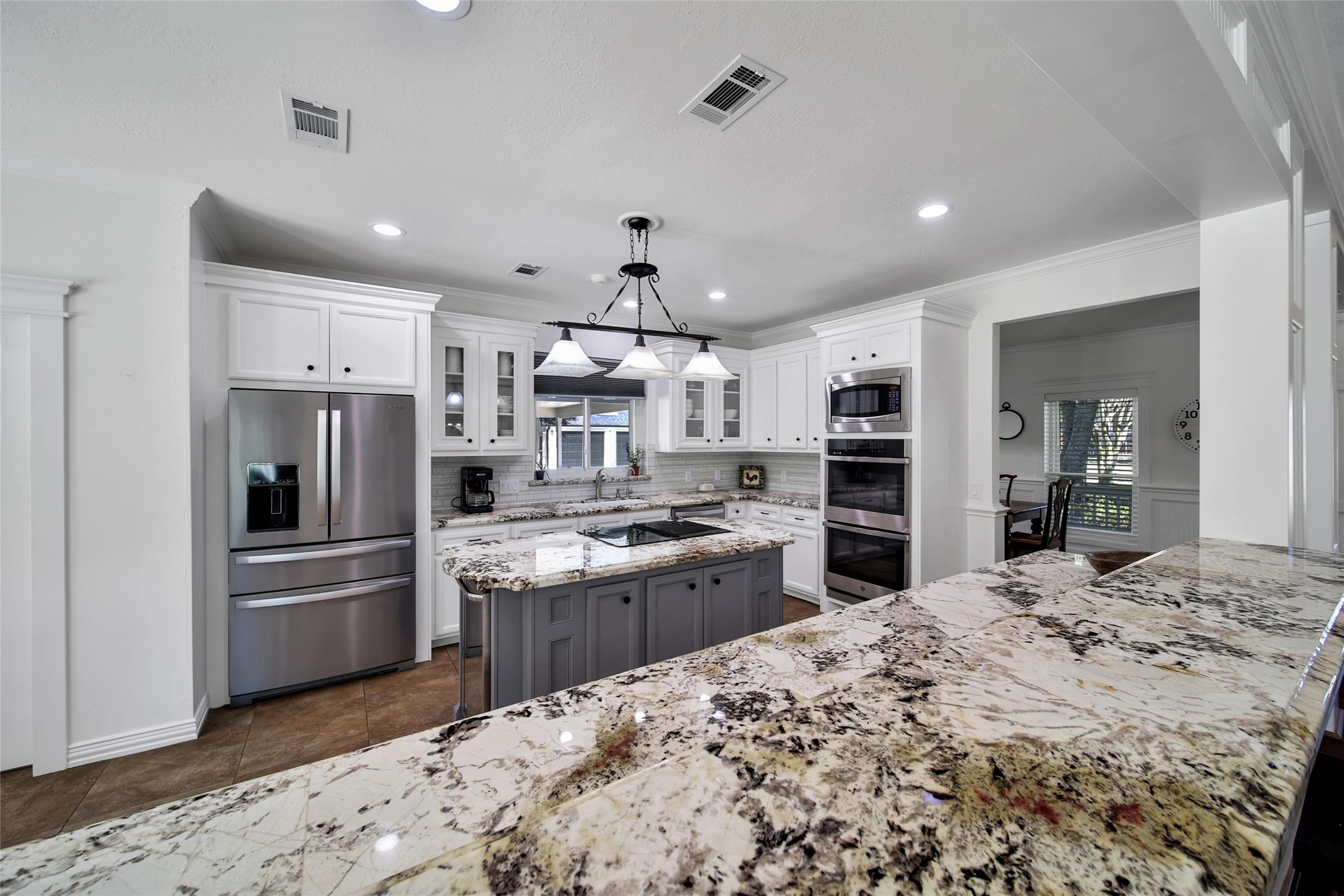 29919 Tudor Way Magnolia, TX 77355 - Photo 9 of 50 a kitchen with stainless steel appliances kitchen island granite countertop a refrigerator and a stove top oven