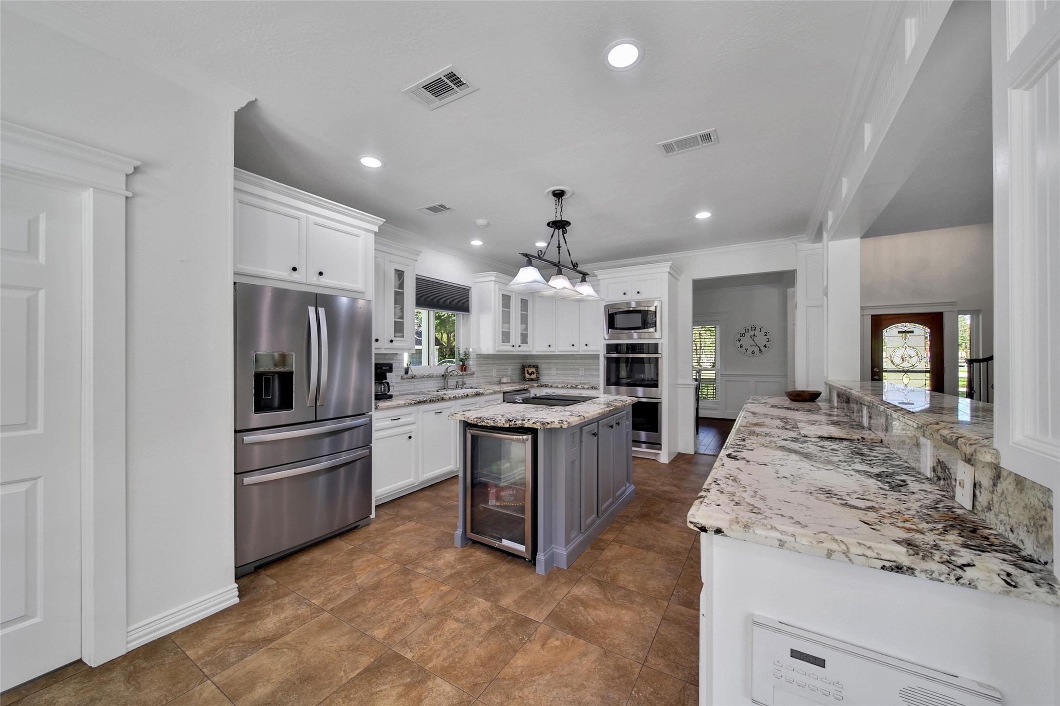 29919 Tudor Way Magnolia, TX 77355 - Photo 10 of 50 a large kitchen with stainless steel appliances kitchen island granite countertop a refrigerator and stove top oven