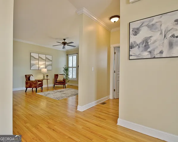 a utility room with closet and wooden floor