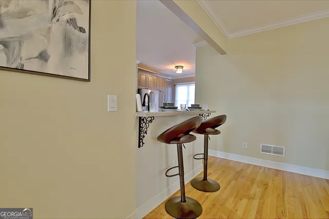 a kitchen with stainless steel appliances a refrigerator and wooden floor
