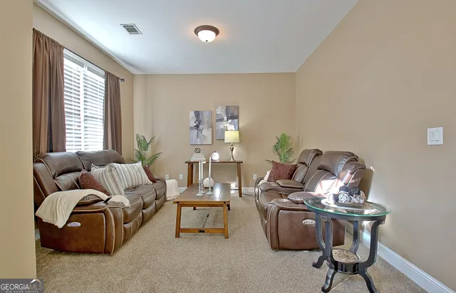 a view of a chairs and table in a backyard