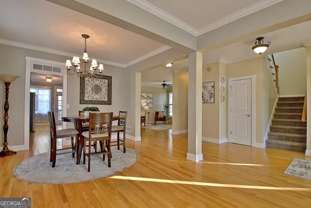 a view of a dining room with furniture and a chandelier