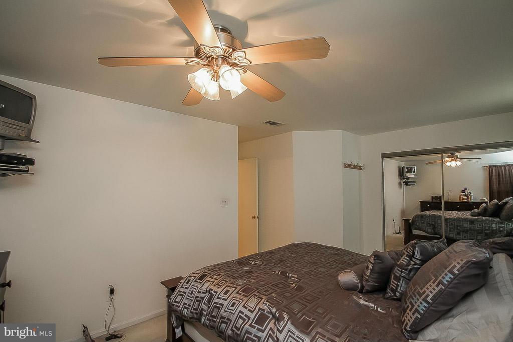 11029 Sentry Ridge Road, Unit 11 Manassas, VA 20109 - Photo 17 of 30 a bedroom with a bed and a chandelier
