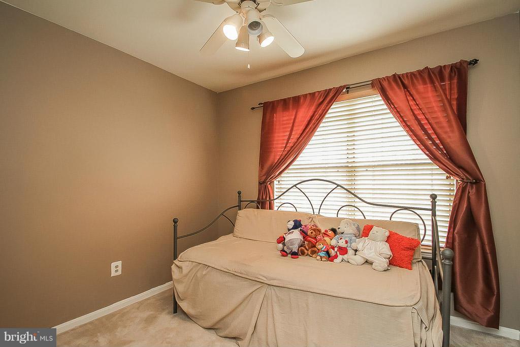 11029 Sentry Ridge Road, Unit 11 Manassas, VA 20109 - Photo 22 of 30 a bedroom with a bed and a chandelier