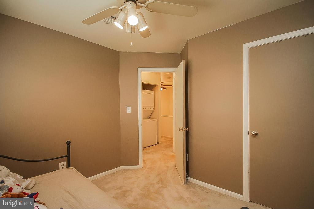 11029 Sentry Ridge Road, Unit 11 Manassas, VA 20109 - Photo 23 of 30 a bedroom with a bed and a chandelier fan