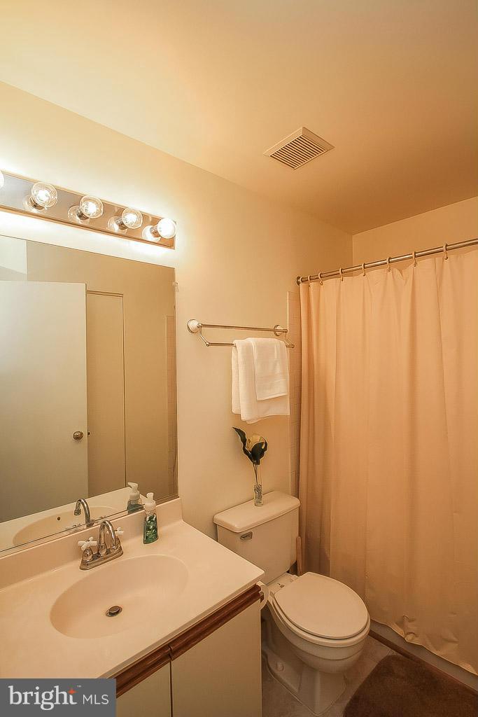 11029 Sentry Ridge Road, Unit 11 Manassas, VA 20109 - Photo 27 of 30 a bathroom with a sink a toilet and shower