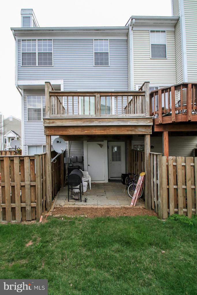 11029 Sentry Ridge Road, Unit 11 Manassas, VA 20109 - Photo 30 of 30 a view of a house with a yard and deck