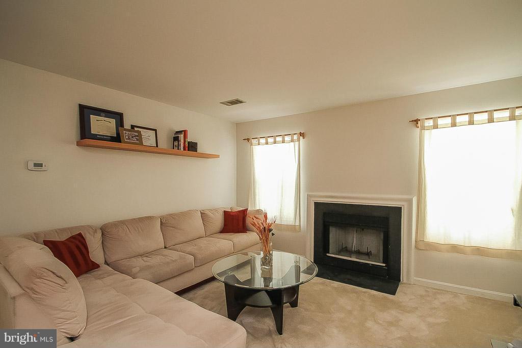 11029 Sentry Ridge Road, Unit 11 Manassas, VA 20109 - Photo 4 of 30 a living room with furniture and a fireplace