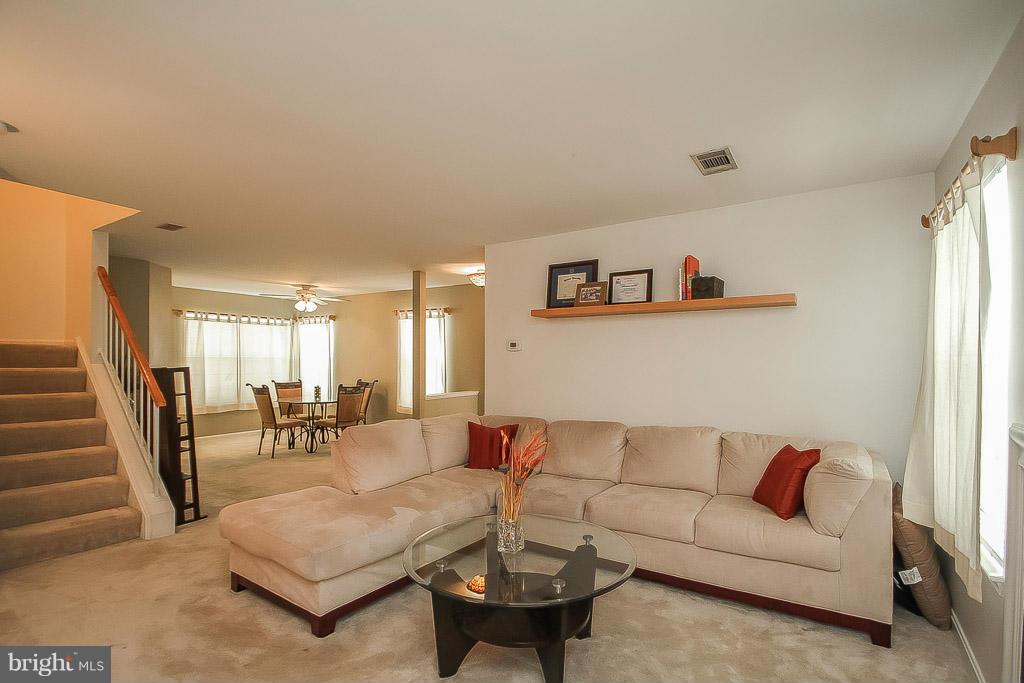 11029 Sentry Ridge Road, Unit 11 Manassas, VA 20109 - Photo 5 of 30 a living room with furniture and wooden floor