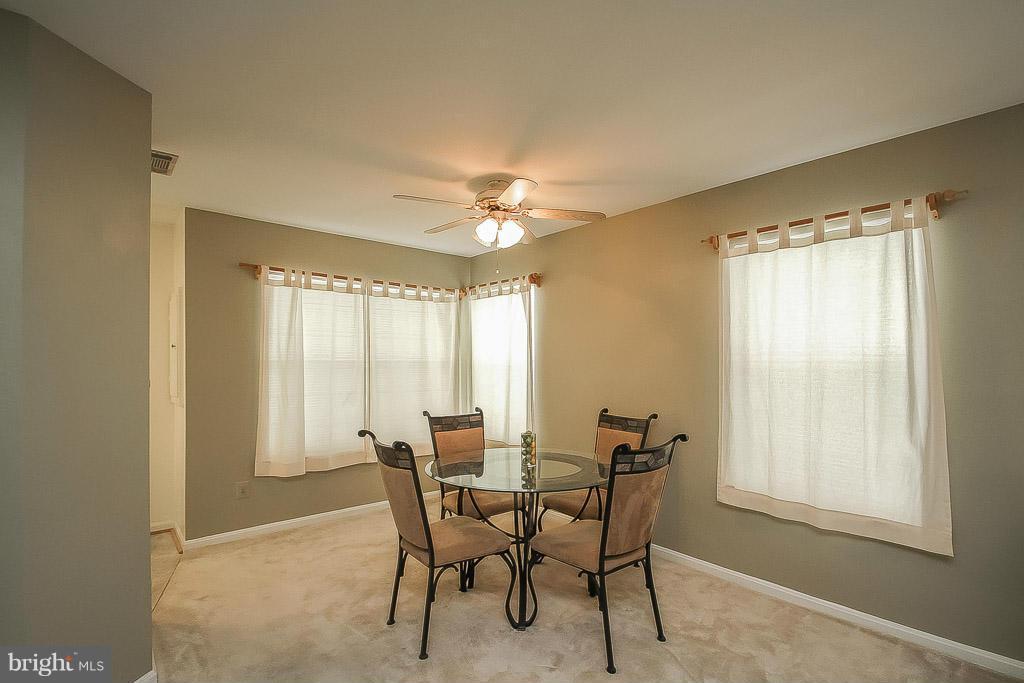 11029 Sentry Ridge Road, Unit 11 Manassas, VA 20109 - Photo 7 of 30 a dining room with furniture and window