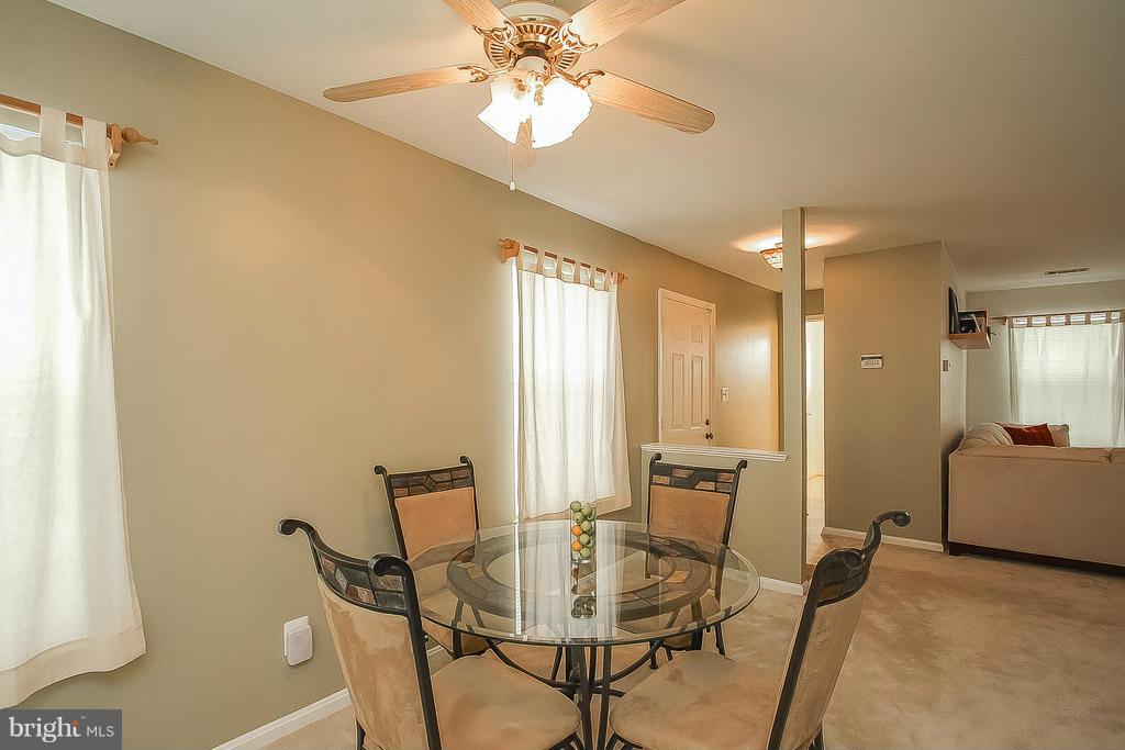 11029 Sentry Ridge Road, Unit 11 Manassas, VA 20109 - Photo 8 of 30 a view of a dining room with furniture and a chandelier