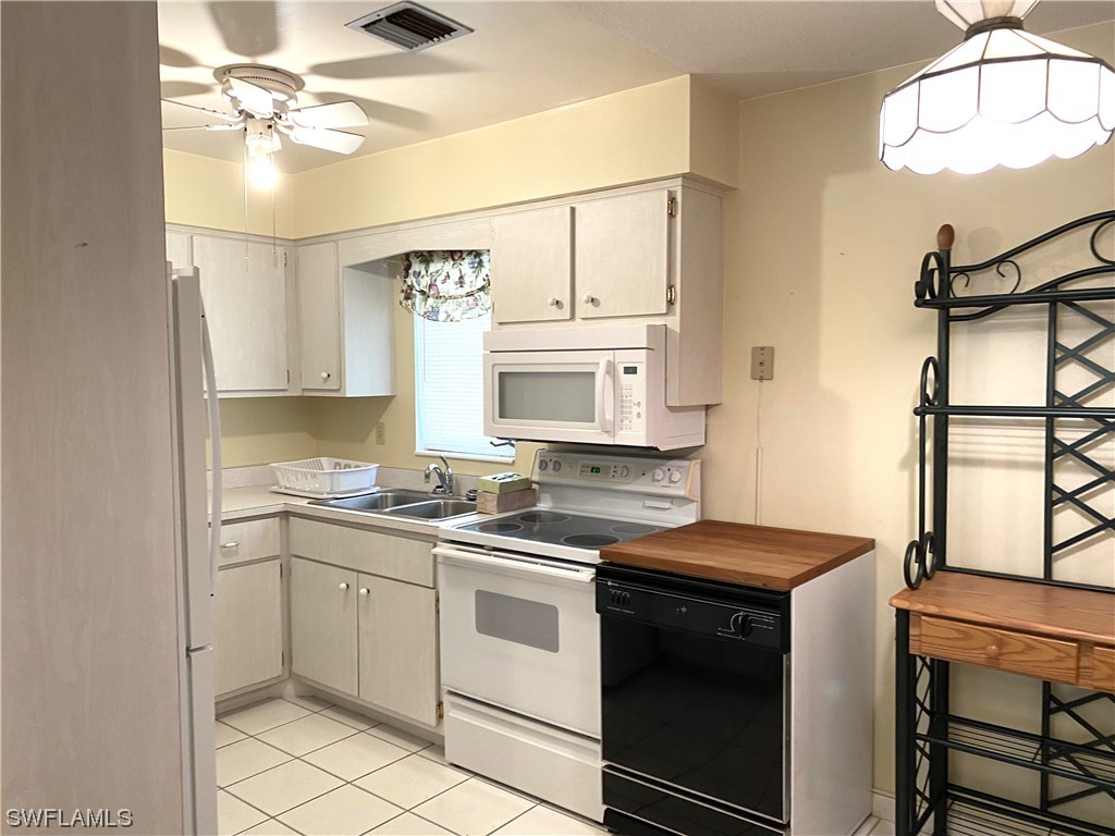 347 Richland Road Lehigh Acres, FL 33936 - Photo 13 of 26 a kitchen that has a stove and a sink
