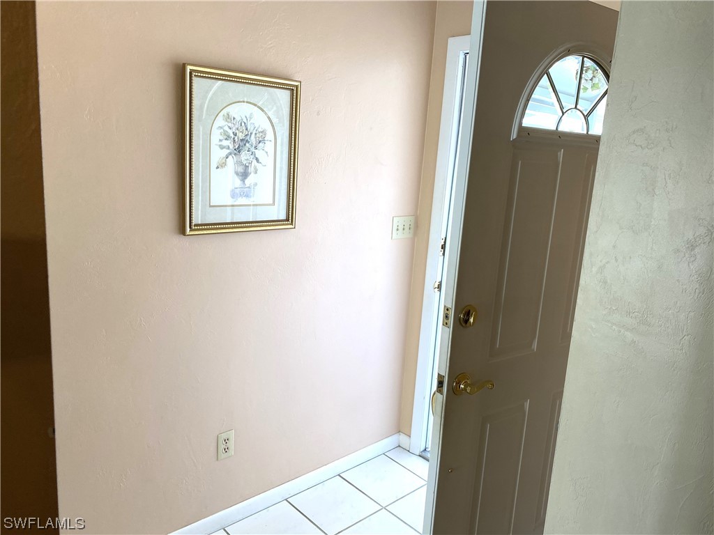 347 Richland Road Lehigh Acres, FL 33936 - Photo 6 of 26 an empty room with wooden floor and a window