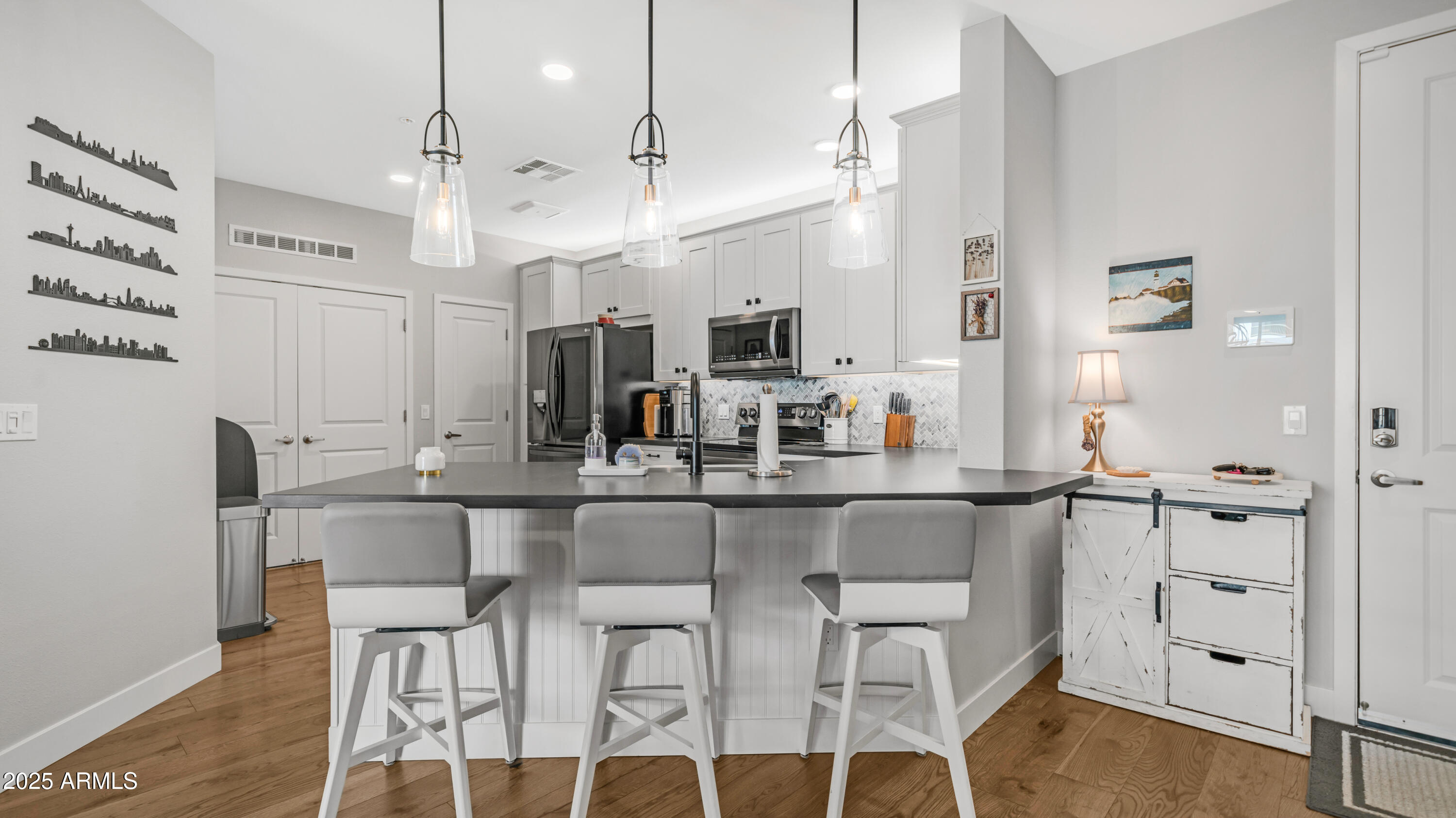 2511 West Queen Creek Road, Unit 166 Chandler, AZ 85248 - Photo 6 of 66 a kitchen with stainless steel appliances kitchen island granite countertop a table and chairs in it